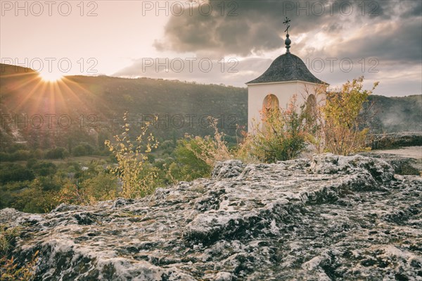 Moldova, Orhei, Trebujeni Rejon, Old church on rocks at sunset
