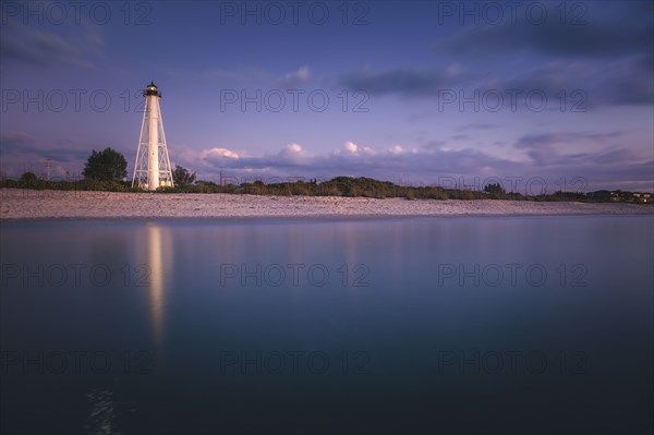 USA, Florida, Boca GrandeLighthouse reflecting in sea at night