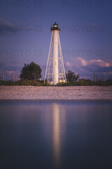 USA, Florida, Boca GrandeLighthouse reflecting in sea at night