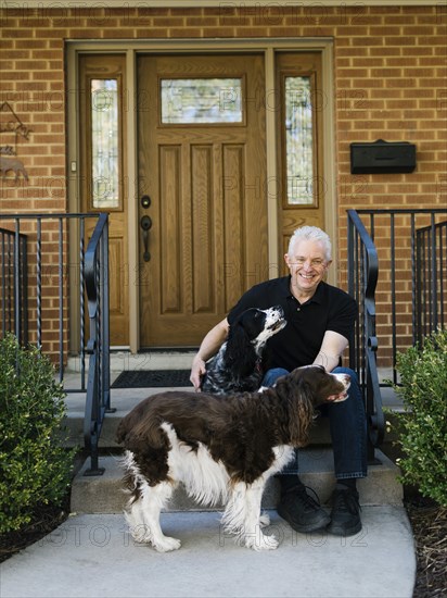 English springer spaniels and owner in front of house