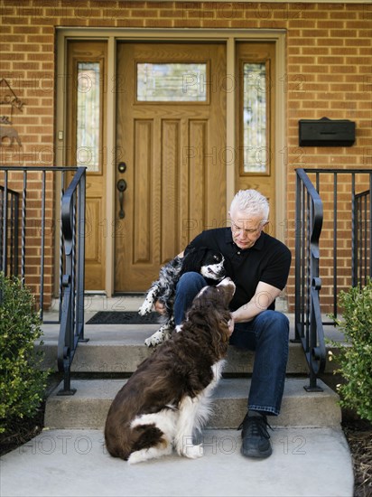 English springer spaniels and owner in front of house