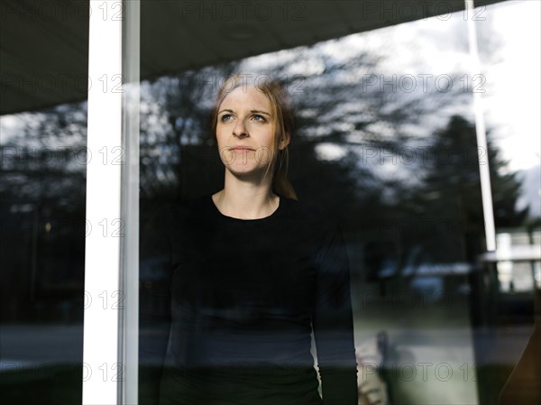 Woman looking through window