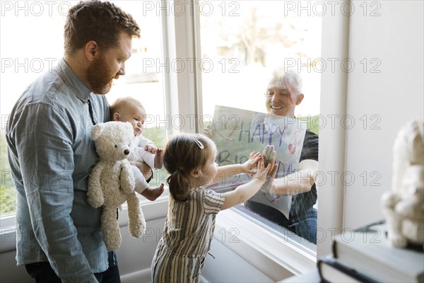 Grandfather visiting family with grandchildren