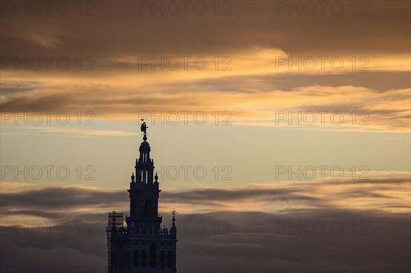 Spain, Seville, Giralda and Catherdral of Seville, Giralda tower against sunset sky