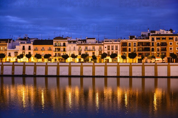Spain, Seville, Triana, Triana neighborhood reflecting in Guadalquivir River