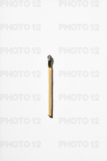 Burnt matchstick on white background