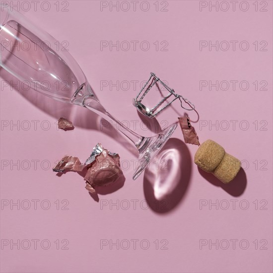 Studio shot of Champagne cork and empty wineglass on pink background