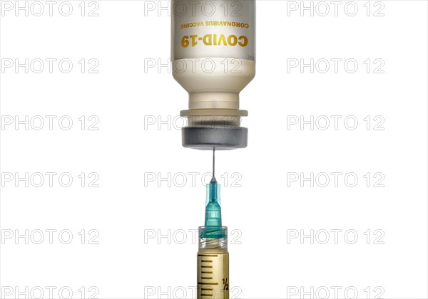Studio shot of Covid-19 vaccine and syringe on white background