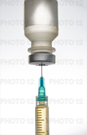 Studio shot of vaccine and syringe on white background