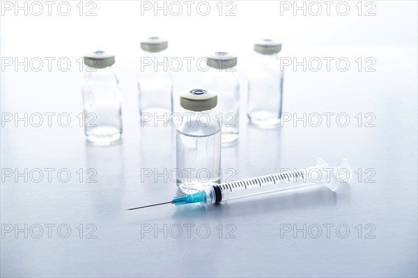 Studio shot of vials and syringe