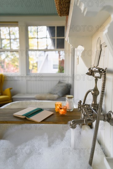 Bubble bath with book and candles