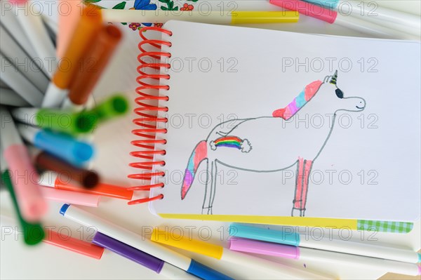 Child's drawing on unicorn with rainbow