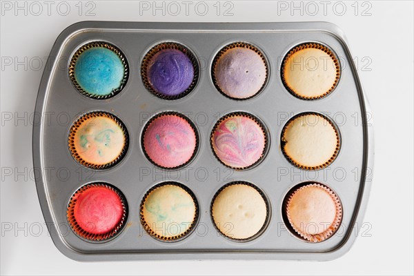 Colorful swirled cupcakes in pan