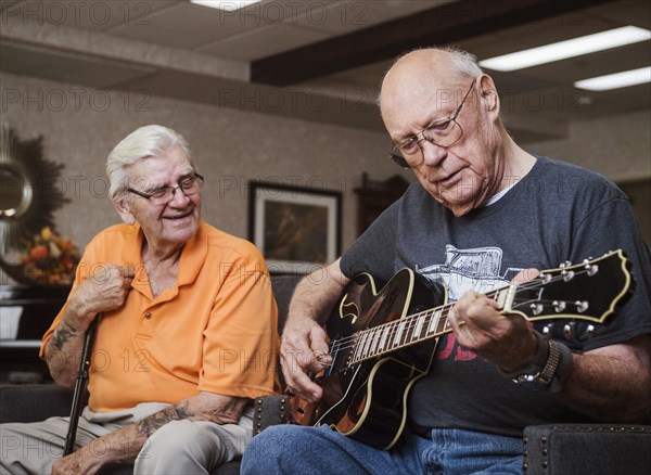 Senior man playing guitar