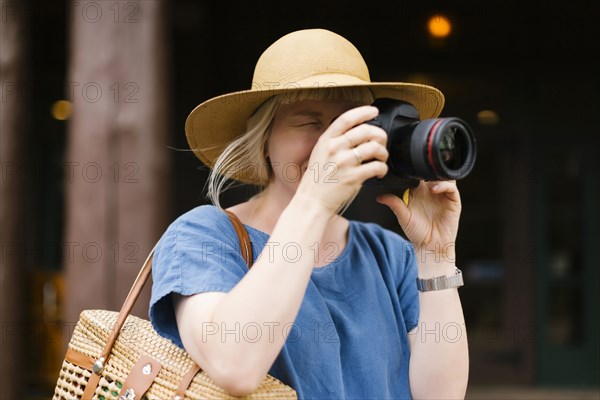 Woman photographing with digital camera