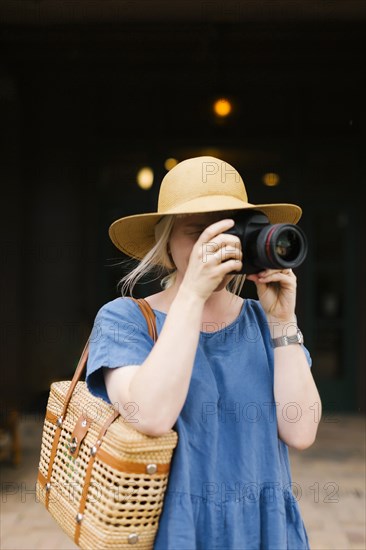 Woman photographing with digital camera