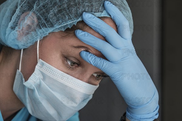 Nurse in face mask experiencing symptoms