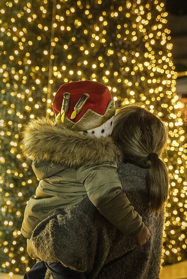 Mother and son watching illuminated Christmas tree