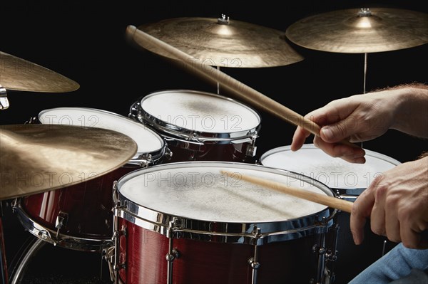 Drummer hands above drum set