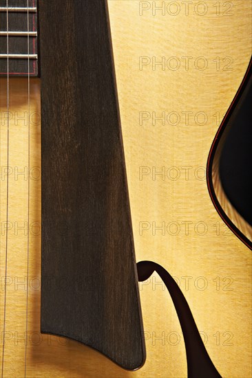 Close up of acoustic guitar saddle