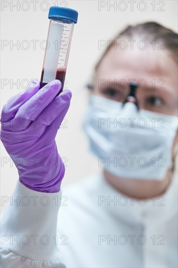 Female technician holding vial