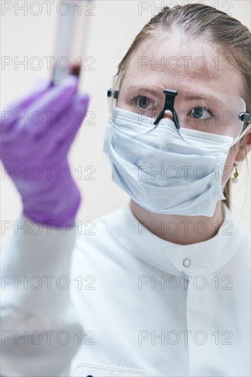 Female technician holding vial