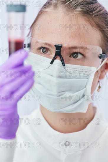 Female technician holding vial