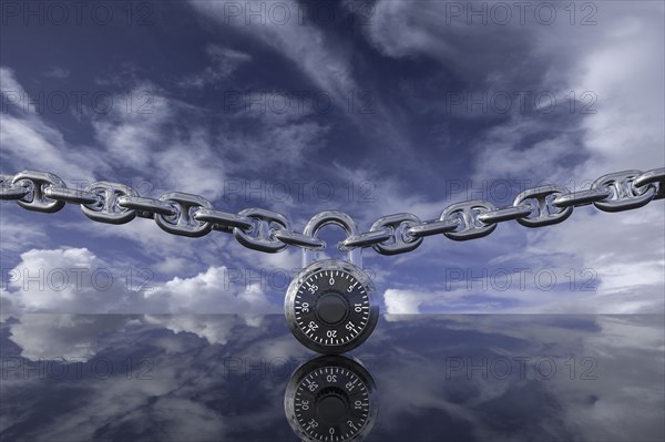 Padlock with chain against clouds