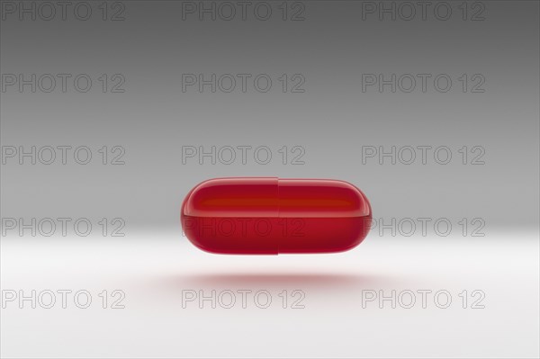 Studio shot of red capsule