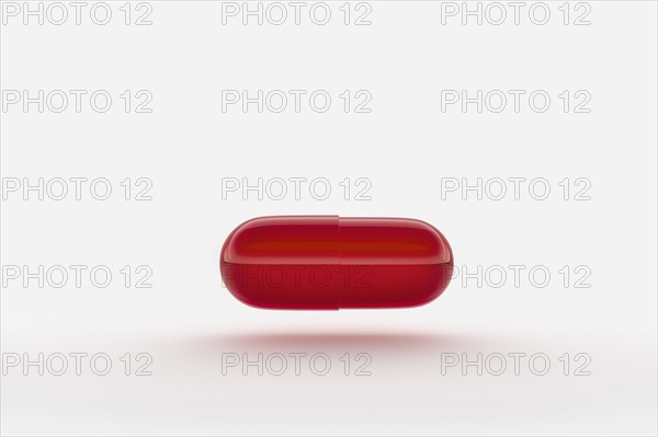 Studio shot of red capsule