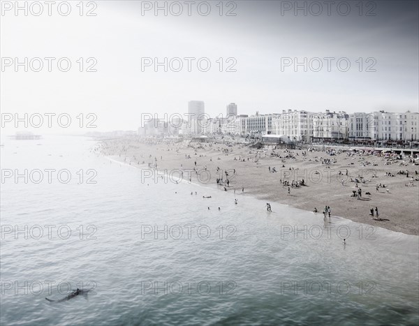 England, Brighton, People resting at urban beach