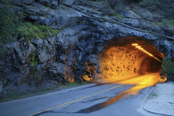 Illuminated tunnel in mountains