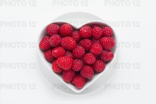 Raspberries in heart-shaped bowl