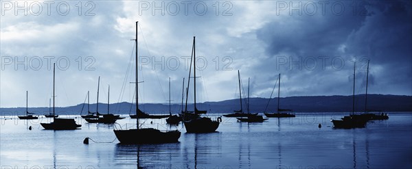 USA, Michigan, Sailboats in harbor at stormy day