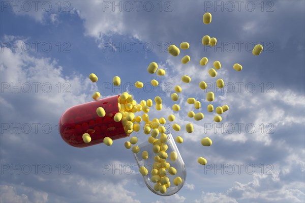 Capsule with yellow pills inside with clouds as background