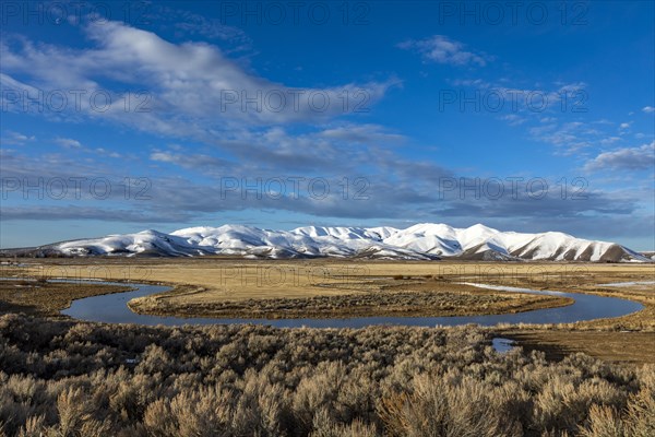 USA, Idaho, Sun Valley, Landscape with oxbow river and snowy mountains in background