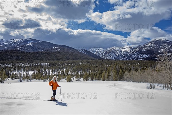 USA, Idaho, Sun Valley, Woman snowshoeing in winter landscape