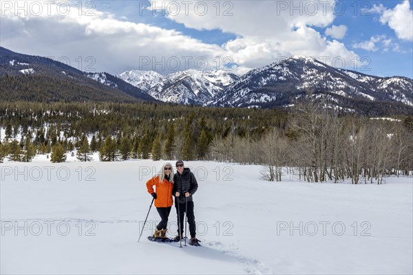 USA, Idaho, Sun Valley, Portrait of man and woman snowshoeing in winter landscape