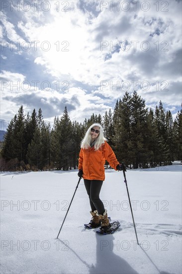 USA, Idaho, Sun Valley, Woman snowshoeing in winter landscape