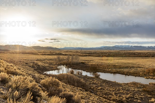 USA, Idaho, Picabo, Sunset over plain and mountain range