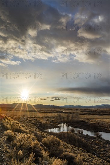 USA, Idaho, Picabo, Sunset over plain and mountain range