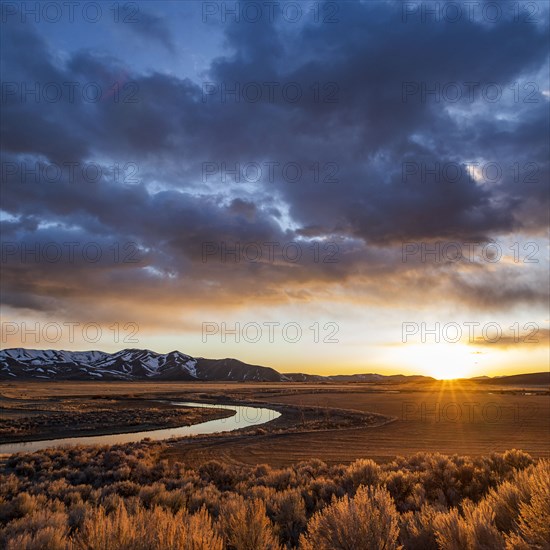 USA, Idaho, Picabo, Sunset over plain and mountain range