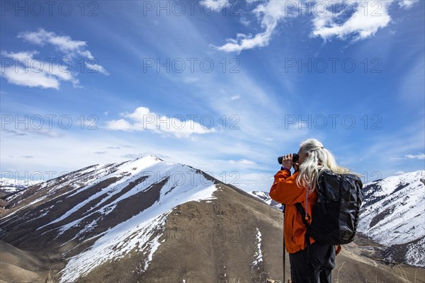 USA, Idaho, Bellevue, Senior woman looking at view through binoculars