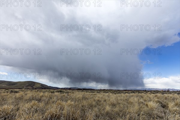 USA, Idaho, Picabo, Storm clouds over fields