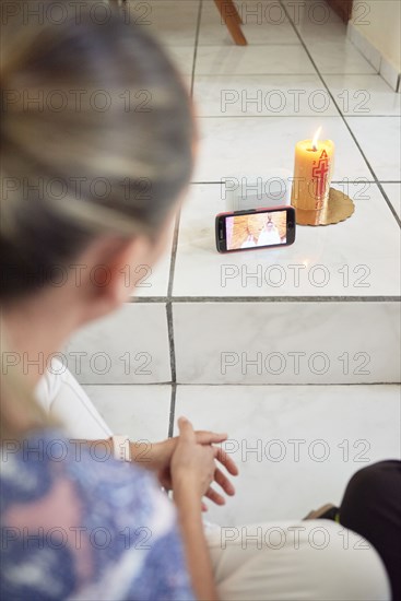 Woman attending mass on cellphone