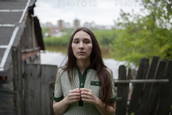 Russia, Omsk, Portrait of young woman in backyard