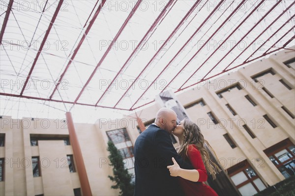 Newlywed couple kissing after ceremony