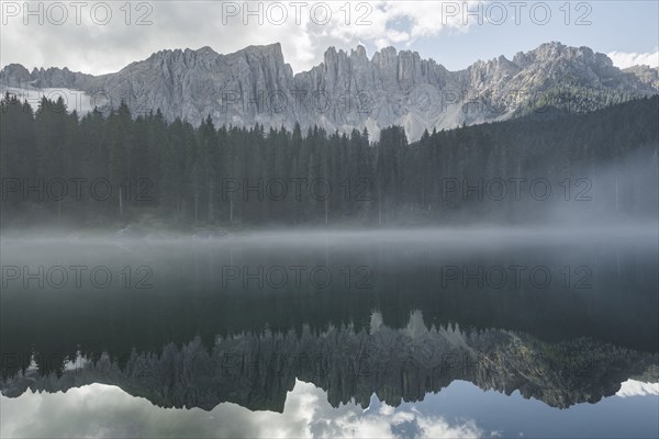 Italy, Carezza, Lago di Carezza in Dolomite Alps at dawn