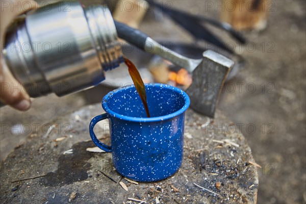 Man pouring coffee at camping