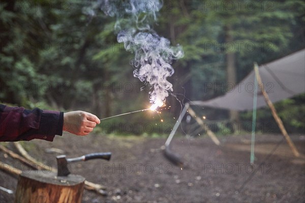Orcas Island, Man holding sparkler at camping